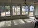 Bright sunroom with multiple windows and access to deck at 18782 Se 50Th St, Ocklawaha, FL 32179