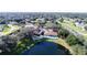 Aerial view of community with pond and clubhouse at 1904 Tweed Ct, Leesburg, FL 34788