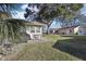 Landscaped backyard with patio and neighboring home visible at 1904 Tweed Ct, Leesburg, FL 34788