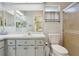 Bathroom with a shower, toilet and updated vanity at 1904 Tweed Ct, Leesburg, FL 34788