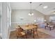 Open dining room and living room with wood flooring and vaulted ceiling at 1904 Tweed Ct, Leesburg, FL 34788