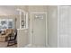 Light beige entryway with a half wall and a white door at 1904 Tweed Ct, Leesburg, FL 34788