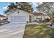 Tan one story house with a screened garage and small front yard at 1904 Tweed Ct, Leesburg, FL 34788