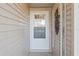 White front door with glass panels, leading into the house at 1904 Tweed Ct, Leesburg, FL 34788