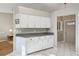 White kitchen cabinets and granite countertops, open to the dining area at 1904 Tweed Ct, Leesburg, FL 34788