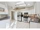 Well-equipped kitchen featuring stainless steel appliances and white cabinets at 1904 Tweed Ct, Leesburg, FL 34788