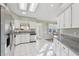 Bright kitchen with stainless steel appliances and white cabinets at 1904 Tweed Ct, Leesburg, FL 34788