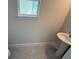 This bathroom has a pedestal sink, modern fixtures, and a window at 2210 Nw 23Rd Loop, Ocala, FL 34475