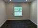 A bright bedroom featuring neutral walls, carpeted floor, and a window offering natural light at 2210 Nw 23Rd Loop, Ocala, FL 34475