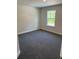 This bedroom features soft carpet, a window with a view, and light walls at 2210 Nw 23Rd Loop, Ocala, FL 34475