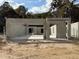 The concrete block construction of the home reveals the frame and layout on a sunny day at 2210 Nw 23Rd Loop, Ocala, FL 34475