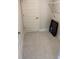 Tiled laundry room featuring a white door, wire shelving, and appliances hook-ups at 2210 Nw 23Rd Loop, Ocala, FL 34475