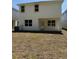 View of the home's backyard, featuring a covered patio area and a spacious grassy area at 2214 Nw 23Rd Loop, Ocala, FL 34475