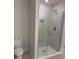 Modern bathroom featuring tiled shower with glass doors and tiled floors at 2214 Nw 23Rd Loop, Ocala, FL 34475