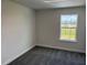 Bedroom featuring carpet floors, neutral walls, and a window overlooking a landscaped lawn at 2214 Nw 23Rd Loop, Ocala, FL 34475