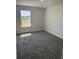 Bright bedroom features plush carpet and a window overlooking the outdoor scenery at 2214 Nw 23Rd Loop, Ocala, FL 34475