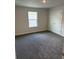 Bedroom features carpet and a large window at 2214 Nw 23Rd Loop, Ocala, FL 34475