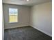 Bedroom featuring carpet floors, neutral walls, and a window overlooking a landscaped lawn at 2214 Nw 23Rd Loop, Ocala, FL 34475