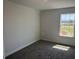 Bright bedroom features plush carpet and a window overlooking the outdoor scenery at 2214 Nw 23Rd Loop, Ocala, FL 34475