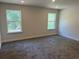 This bedroom features two windows offering natural light and neutral paint on the walls and plush gray carpet at 2214 Nw 23Rd Loop, Ocala, FL 34475