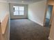 Bonus room features neutral walls, carpet, window, and door to another space at 2214 Nw 23Rd Loop, Ocala, FL 34475