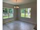 Bright dining area with tile floors, chandelier, and large windows overlooking the backyard at 2214 Nw 23Rd Loop, Ocala, FL 34475