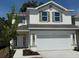 Charming two-story home featuring a two-car garage, white siding, and well-maintained landscaping at 2214 Nw 23Rd Loop, Ocala, FL 34475