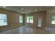 Open-concept living room with abundant natural light and sleek tile flooring at 2214 Nw 23Rd Loop, Ocala, FL 34475