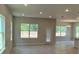 Open-concept living room with abundant natural light and sleek tile flooring at 2214 Nw 23Rd Loop, Ocala, FL 34475