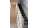Staircase with carpeted steps and a painted wood banister leading to the upper level at 2214 Nw 23Rd Loop, Ocala, FL 34475