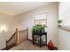 Bright landing area with decorative plants and a wooden staircase at 2701 Ne 10Th St # 707, Ocala, FL 34470