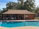 Community pool with covered patio and seating area at 2701 Ne 10Th St # 707, Ocala, FL 34470