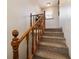 Wooden staircase with carpeted steps and wooden railing at 2701 Ne 10Th St # 707, Ocala, FL 34470