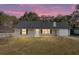 House exterior at dusk, gray siding, and landscaping at 43 Teak Crse, Ocala, FL 34472