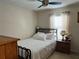 Bedroom with a metal bed frame and ceiling fan at 4517 Se 28Th St, Ocala, FL 34480