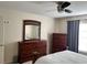 Bedroom with wood dresser and ceiling fan at 4517 Se 28Th St, Ocala, FL 34480