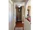 Clean hallway with wood floors and neutral walls, leading to other rooms at 4517 Se 28Th St, Ocala, FL 34480