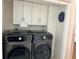 Laundry room with Samsung washer and dryer, and upper cabinets at 4517 Se 28Th St, Ocala, FL 34480