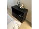 Black nightstand with drawers and decorative items at 4517 Se 28Th St, Ocala, FL 34480