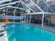 Enclosed pool area with patio furniture and lush landscaping at 4517 Se 28Th St, Ocala, FL 34480