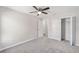 Bright bedroom with carpeted floor, ceiling fan, and spacious closet at 5 Pine Course Loop, Ocala, FL 34472