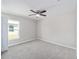 Spacious bedroom featuring carpeted floors and a window with natural light at 5 Pine Course Loop, Ocala, FL 34472