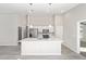 White kitchen island with quartz countertop and stainless steel sink at 5 Pine Course Loop, Ocala, FL 34472