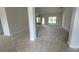 Spacious living room with light grey carpet and tile flooring near the entry at 5322 Sw 137Th Ct, Ocala, FL 34481