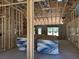 Unfinished room interior with wooden framing and stacks of sheetrock at 5322 Sw 137Th Ct, Ocala, FL 34481