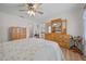 Main bedroom with ceiling fan, dresser, and ensuite bathroom at 5894 Sw 102Nd Ln, Ocala, FL 34476