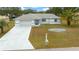 Single-story home with attached garage and landscaped yard at 5894 Sw 102Nd Ln, Ocala, FL 34476