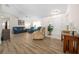 Living room with blue sofa and wood-look floors, near entryway at 5894 Sw 102Nd Ln, Ocala, FL 34476