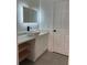 Bright bathroom featuring a contemporary vanity and floating shelves at 5921 Se 4Th Pl, Ocala, FL 34472