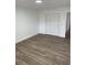 Spacious bedroom with new wood-look flooring and a large closet at 5921 Se 4Th Pl, Ocala, FL 34472